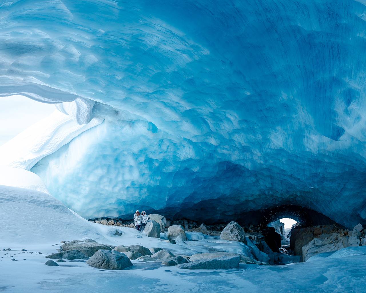 Heli ice cave tour visit a large ice cave with an interpretive guide