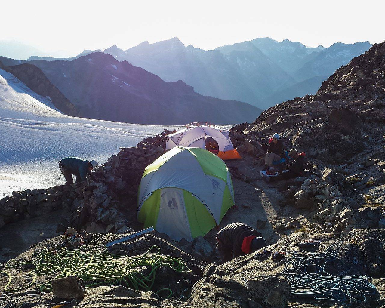 Camp setup during mountaineering trip with glacier in background