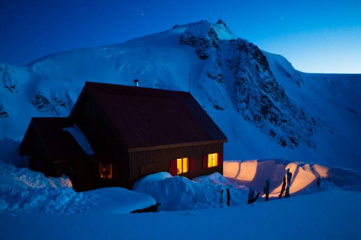 Backcountry Ski hut at night in mountains