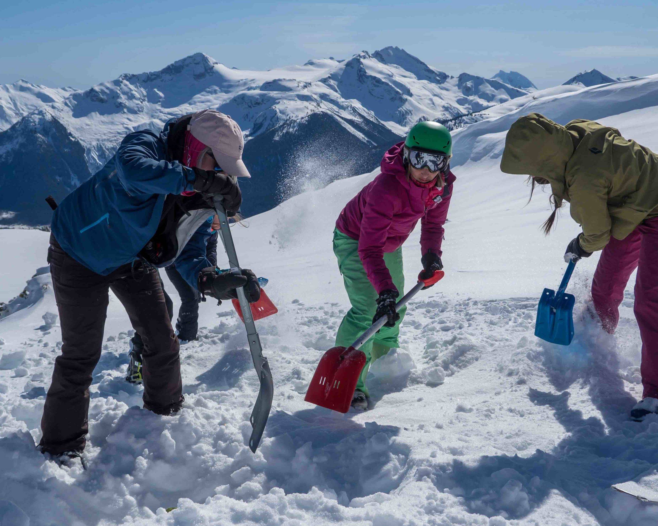 Digging for buried victim during avalanche skills course