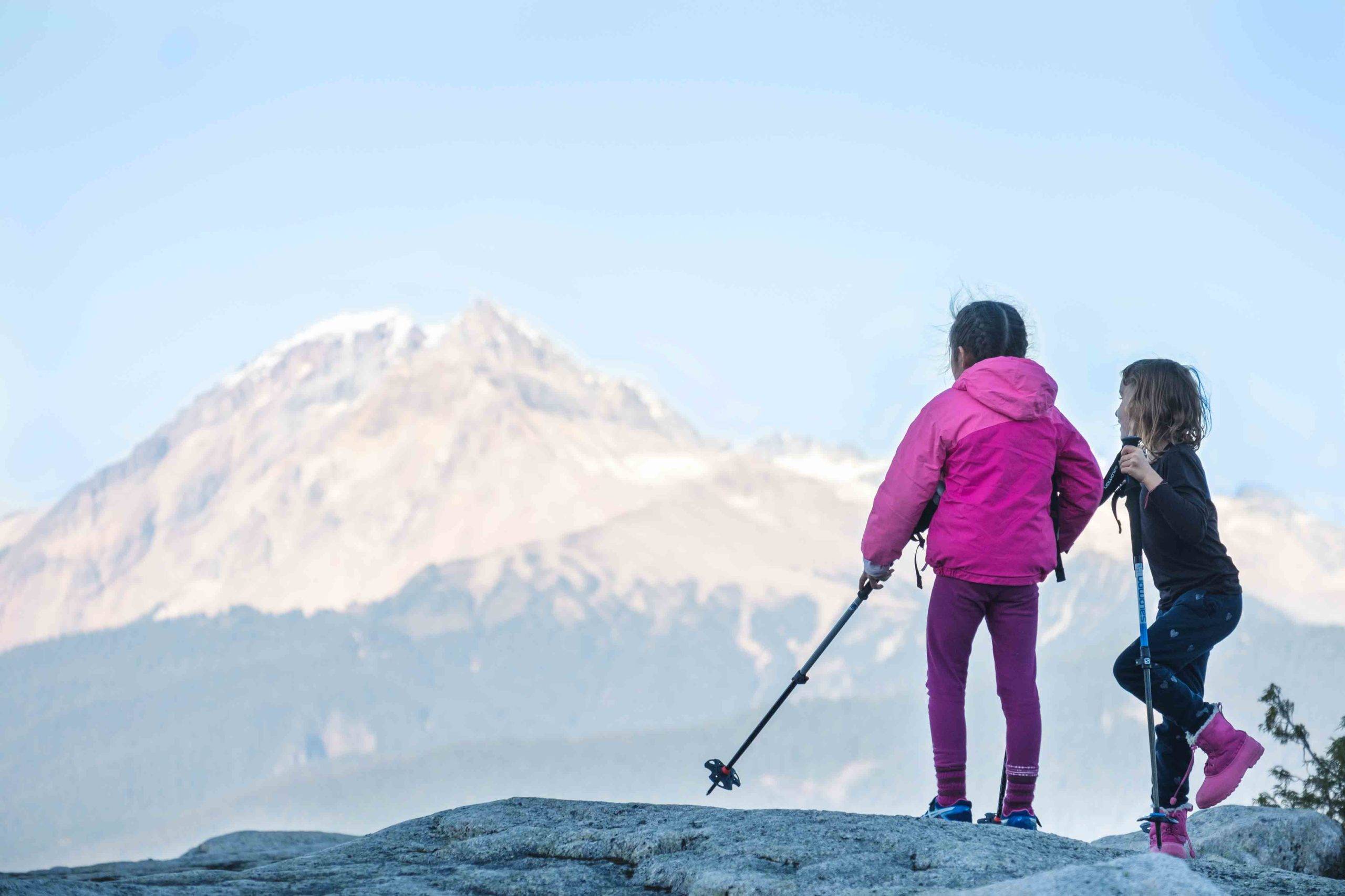 children overlooking alpine mountains