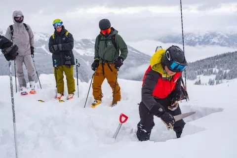 A group of skiers enjoying an adventurous day on the snowy slopes of Canada.